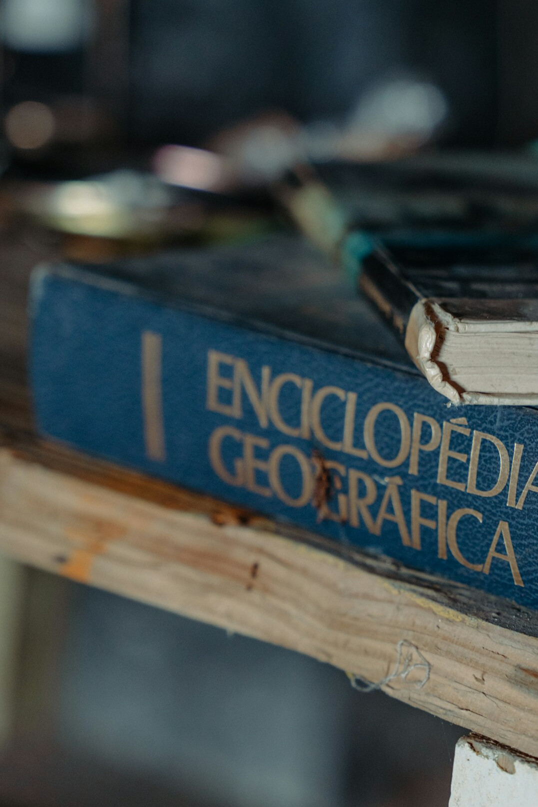 Stack of old books with a magnifying glass on top