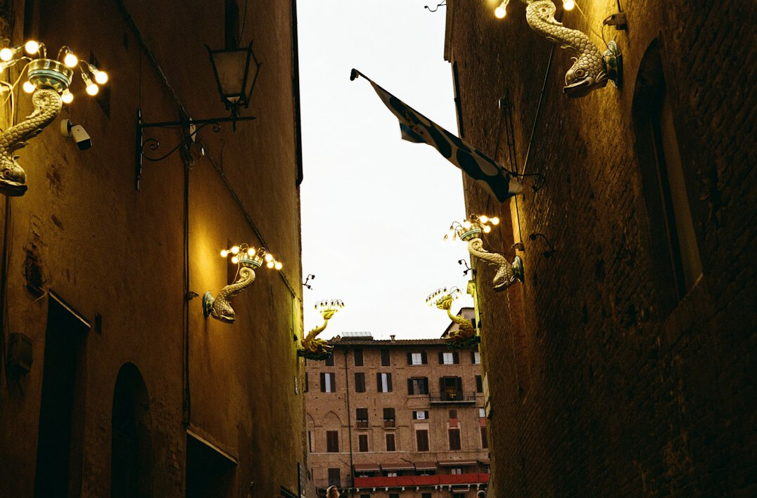 Narrow old city street with historic buildings at dusk
